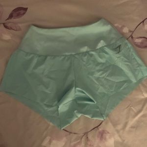 Teal Gymshark athletic shorts with zipper pocket